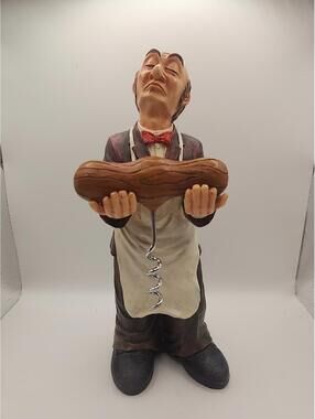 Old wine Butler holding a wine opener